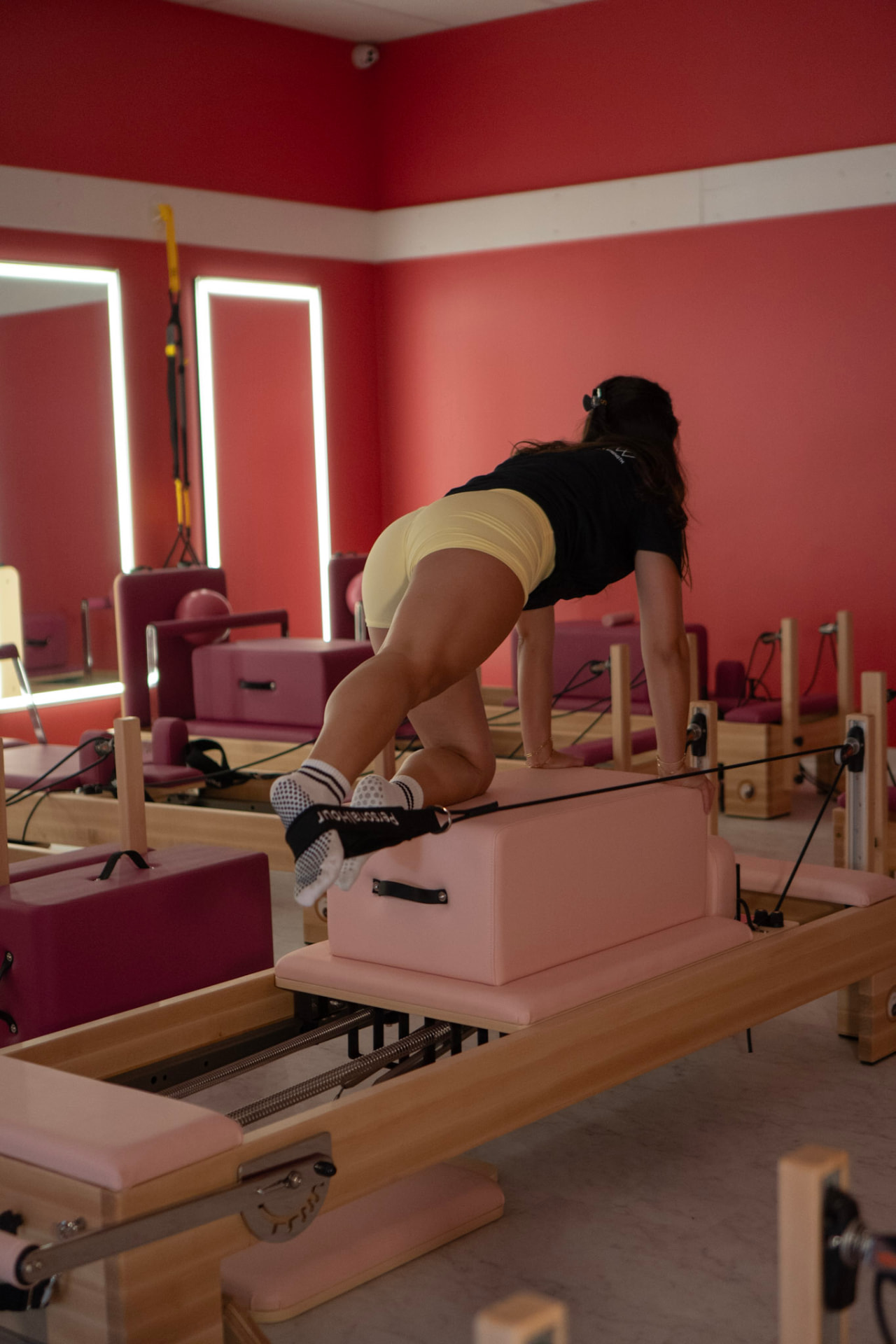 Client in grippy socks working on the reformer with the jump box